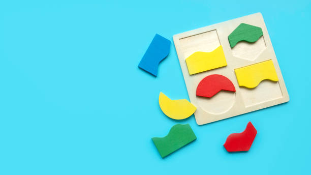 istock Educational toys, Cognitive skills, kid development logical thinking concept. Colorful Montessori geometric shapes toys over a blue background.Sorter for different shapes and color. 1847268783