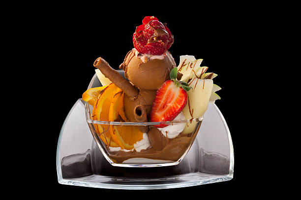 Close-up of a creamy dessert topped with sliced citrus fruits and a red berry sauce. The dessert is served in a glass dish and appears light and refreshing. It's a visually appealing treat, perfect for a sweet indulgence.