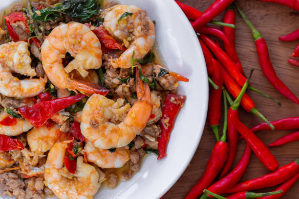 Stir-Fried Spicy Seafood, Stir-fried red curry with shrimp, mussels, scallops, squids, crabmeat, fish balls, bamboo shoots, green beans, basil leaves and eggplant