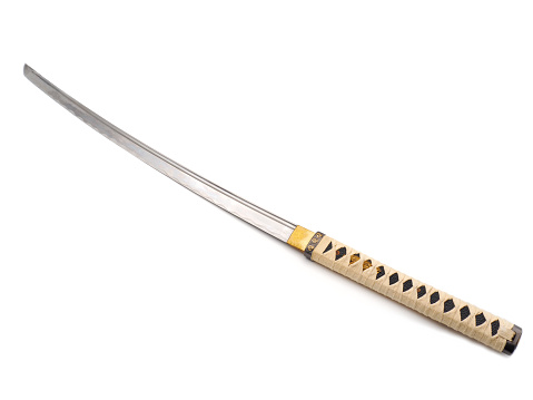 A katana is a Japanese sword characterized by a curved, single-edged blade with a circular or squared guard and long grip to accommodate two hands.