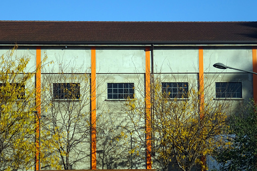 1950s industrial warehouse side view with exposed windows and pillars - urban particular