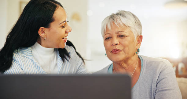istock Woman, elderly mom and laptop with teaching, reading and typing for email notification, web or search. Computer, senior mother and daughter with click, learning and family home lounge on social media 1847335321
