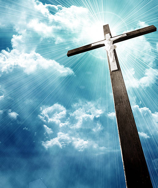 istock cross in sunrays against cloudy sky 184734858