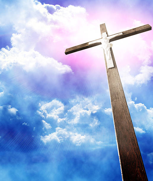 istock cross in sunrays against cloudy sky 184734860