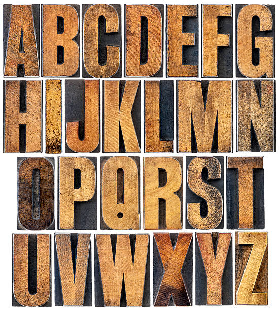 vintage wood type alphabet complete English alphabet - a collage of 26 isolated vintage wood letterpress printing blocks, scratched and stained by ink printing block photos stock pictures, royalty-free photos & images