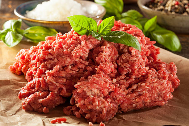 Organic Raw Grass Fed Ground Beef Organic Raw Grass Fed Ground Beef on Butcher Paper ground beef photos stock pictures, royalty-free photos & images