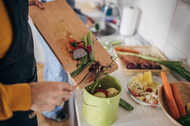 istock Smiling Couple Composting While Cooking at Home 1847357401