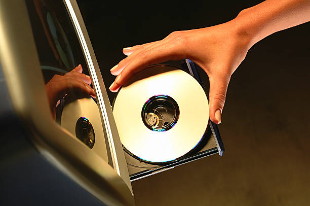 cd on computer cd on computer cd player stock pictures, royalty-free photos & images