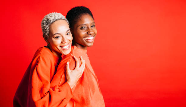 istock Two women wearing red clothes in studio 1847400616