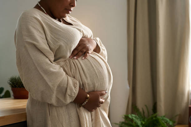 istock Pregnant woman stroking her belly 1847401718