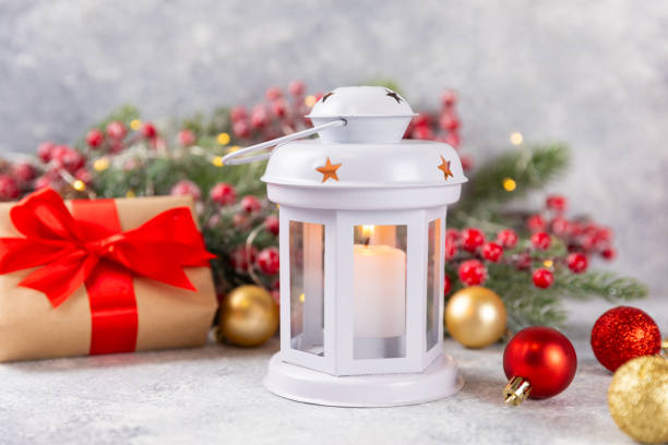 Christmas lantern with Christmas tree branch. Winter decoration background. Lantern with candles and Christmas decorations on a wooden background. New Year and Christmas concept.Banner. Copy Space.