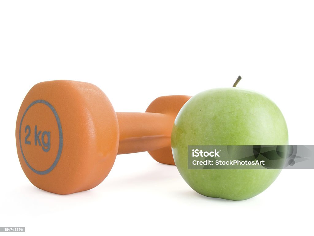 dumbbell and an apple Fitness dumbbell and an apple Anaerobic Exercise Stock Photo