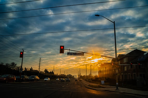 Red traffic lights and cloudy sunset sky on the street of Toronto, Canada
