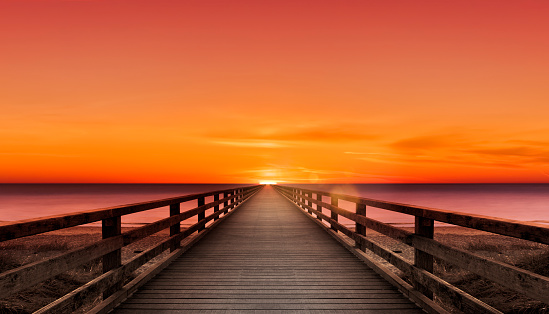 Wooden walkway by the sea to the horizon