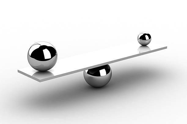 istock Metal board balancing on a ball with two balls on each side 184744731