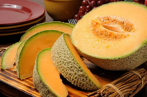 Fresh sliced cantaloupe on a cutting board