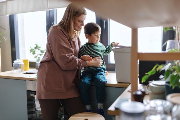 istock Woman teaching a little boy to recycle 1847458945