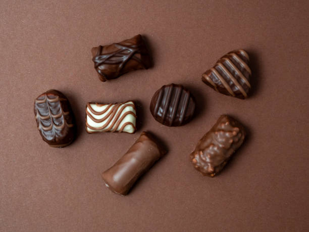 istock A varied assortment of chocolates arranged on a rich brown background. 1847467406