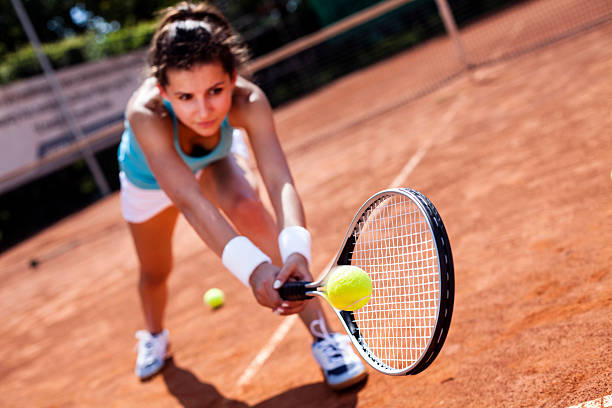 Beautiful girl smiling with a tennis racket stock photo