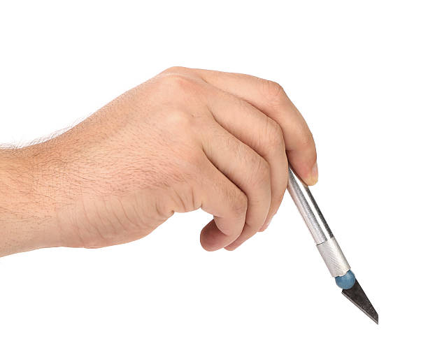 istock Hand holds aluminium Craft Knife 184746872
