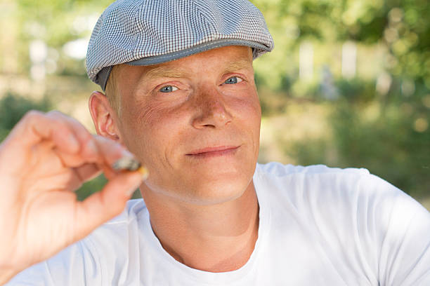 istock Middle-aged relaxed Caucasian man smoking outdoors 184747005