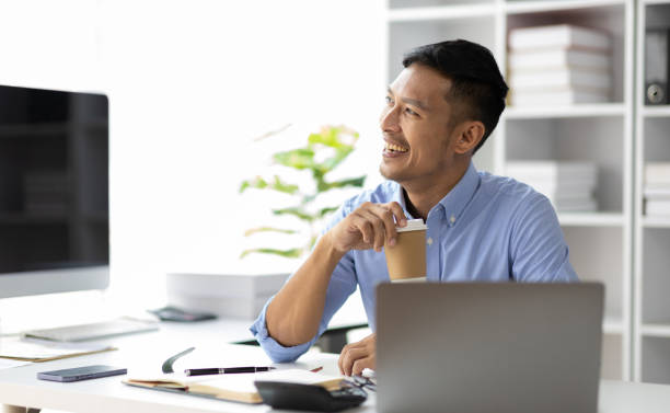 istock Businessman working with laptop computer in office and drinking coffee in the morning. 1847471613