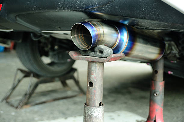 istock Car 's changing new exhaust pipe on tripod hand jack. 184747216