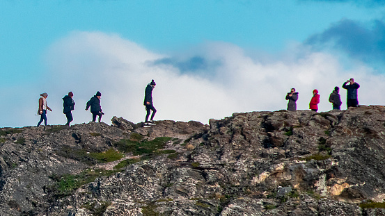 Ushuaia, Argentina; April 15 2022: Group of tourist walking at top of island hill, tierra del fuego, argentina