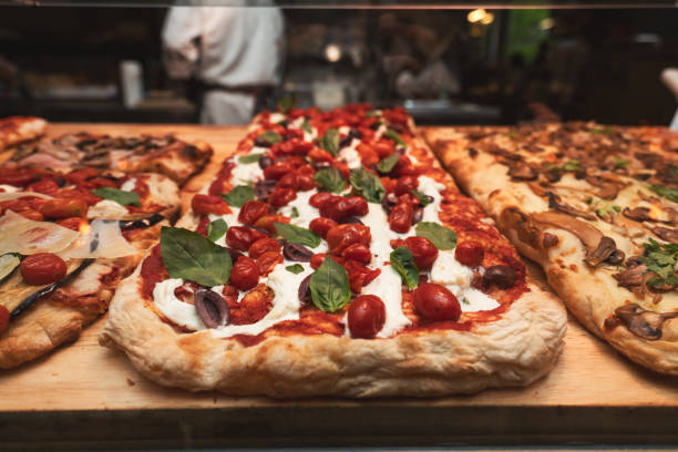 istock Pizza with tomatoes, mozzarella cheese, olive and basil leaves  in store. 1847501321