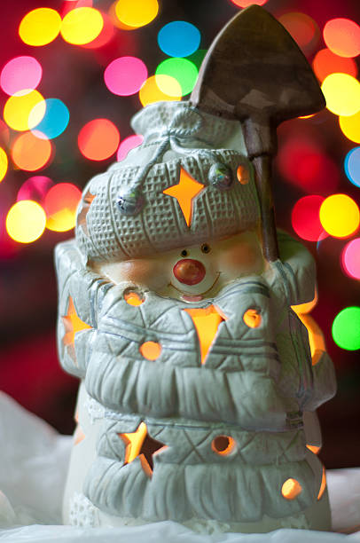 istock Snoman on the christmass tree bokeh lights 184751277