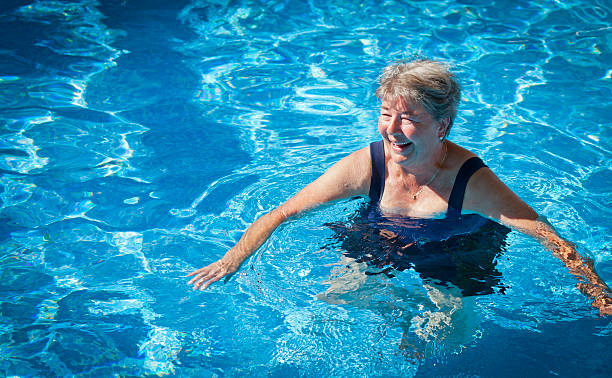 Senior Woman Swimming in the Pool stock photo