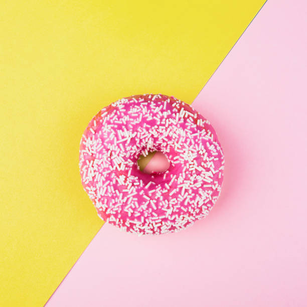 istock Pink donut on color background, flat lay, top view 1847537798