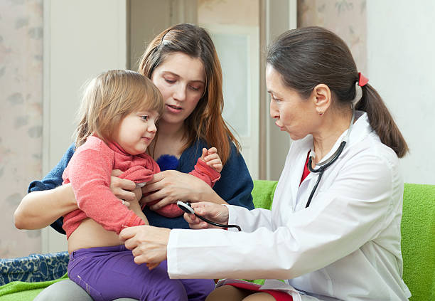 istock doctor examining 2 years baby with stethoscope 184754427