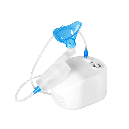 Compressor nebulizer with face mask on a white background. Inhalation medical equipment