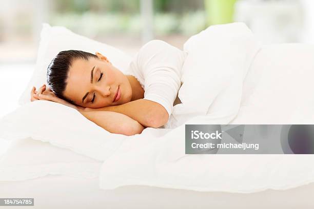 Pretty Young Woman Sleeping In Fluffy Bed With White Sheets Stock Photo - Download Image Now