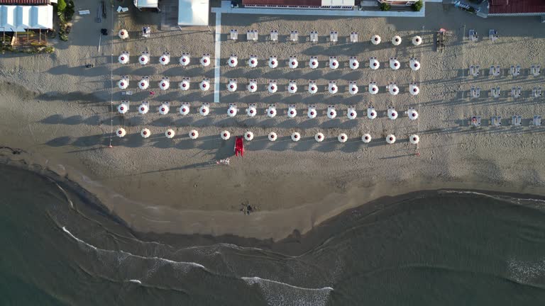 Aerial view of a beach with many beach umbrellas