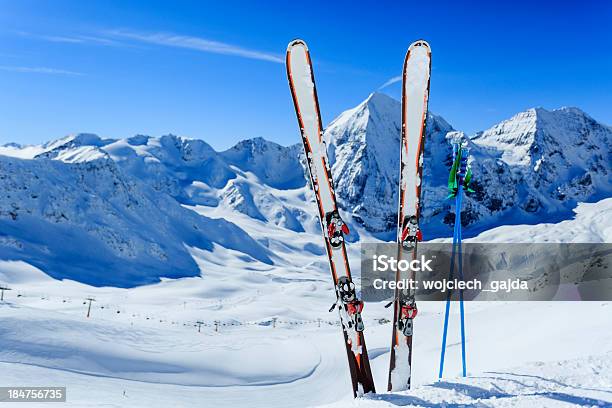 Image Of Ski Gear Stuck In Snow Against Mountain Backdrop Stock Photo - Download Image Now