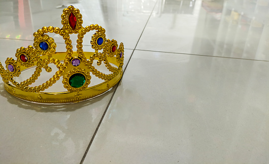 Gold crown on floor queen, leader, VIP person. Business concept success and achievement