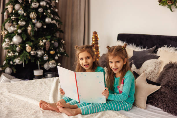 istock Cute twins reading christmas stories before sleep 1847569551