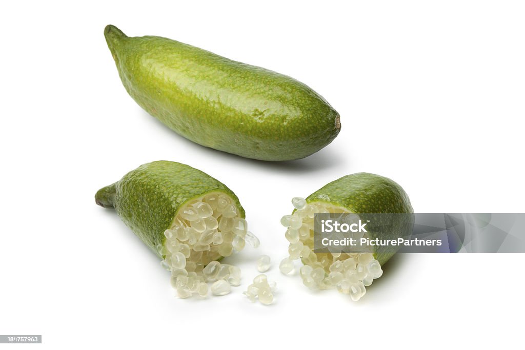 Whole and half lime fingers Whole and half green lime fingers on white background Australia Stock Photo