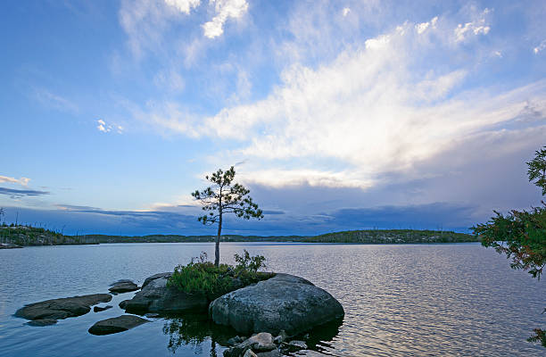 Storm Clouds coming in a Sunset Sunset and Clouds on Alpine Lake in the Boundary Waters Canoe Area boundary waters canoe area stock pictures, royalty-free photos & images