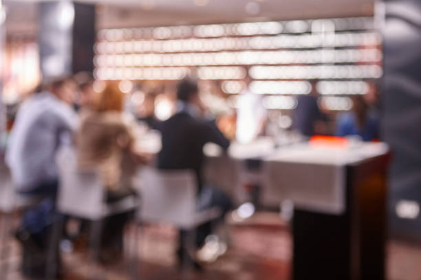 Defocus effect. Restaurant interior with people. Seated persons