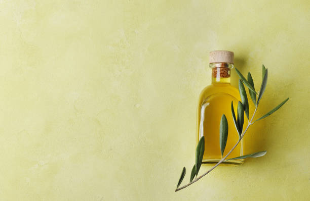 istock Olive oil bottle on a green background. Space for text. 1847611719