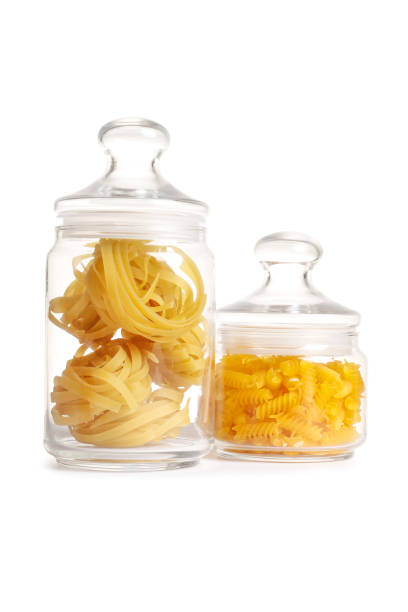 istock Raw pasta in a glass jar isolated on a white background. 1847617502
