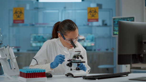 istock Portrait of chemist working with microscope in laboratory 1847627089