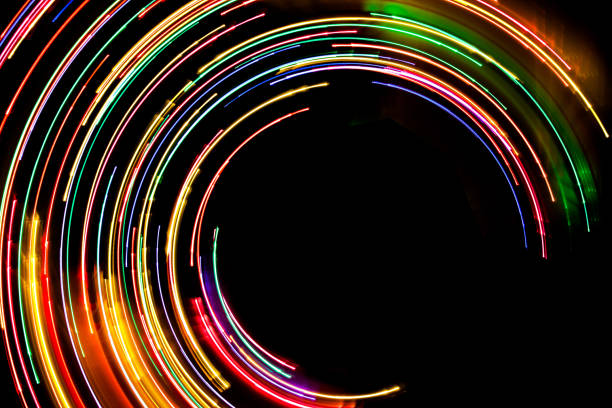 istock Neon circle lines with empty copy space isolated on black background. Colorful led lights long exposure rotation photo. Eco shiny light glow. 1847628154