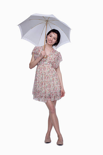 Young, beautiful, gentle woman with an umbrella walking in the park in rainy day and she enjoying the fresh air...