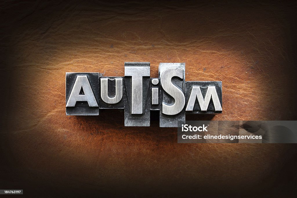 Autism The word Autism made from vintage lead letterpress type on a leather background. Autism Stock Photo