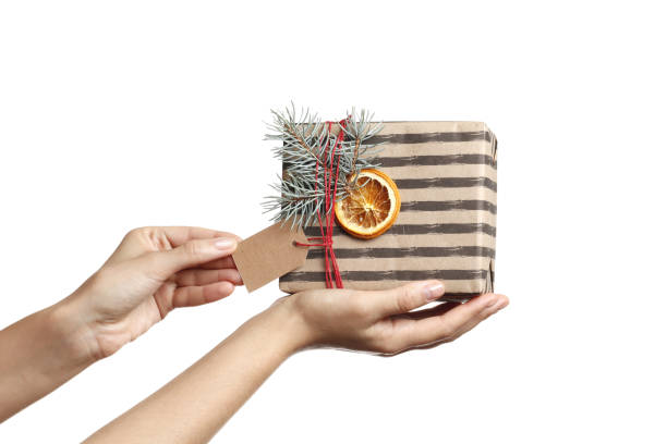 istock Decorative Festive Gift Box in a female hand on a white background. place for text. Top view. Mothers Day. Christmas. Birthday. Valentine's Day. 1847645623