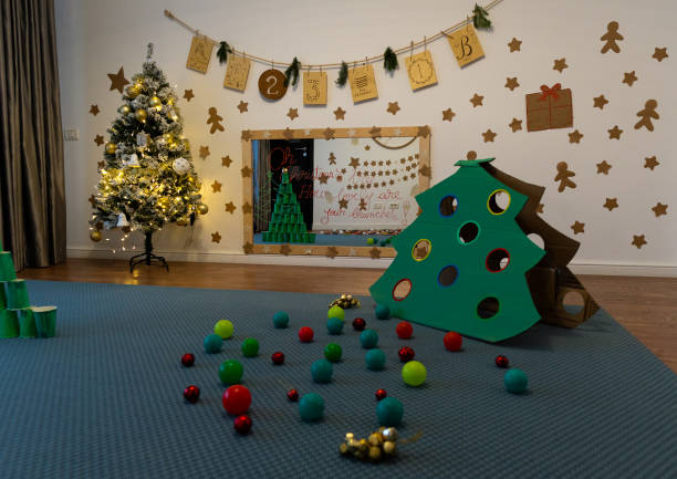 istock Play room with lit up Christmas tree and wall decorations 1847655029